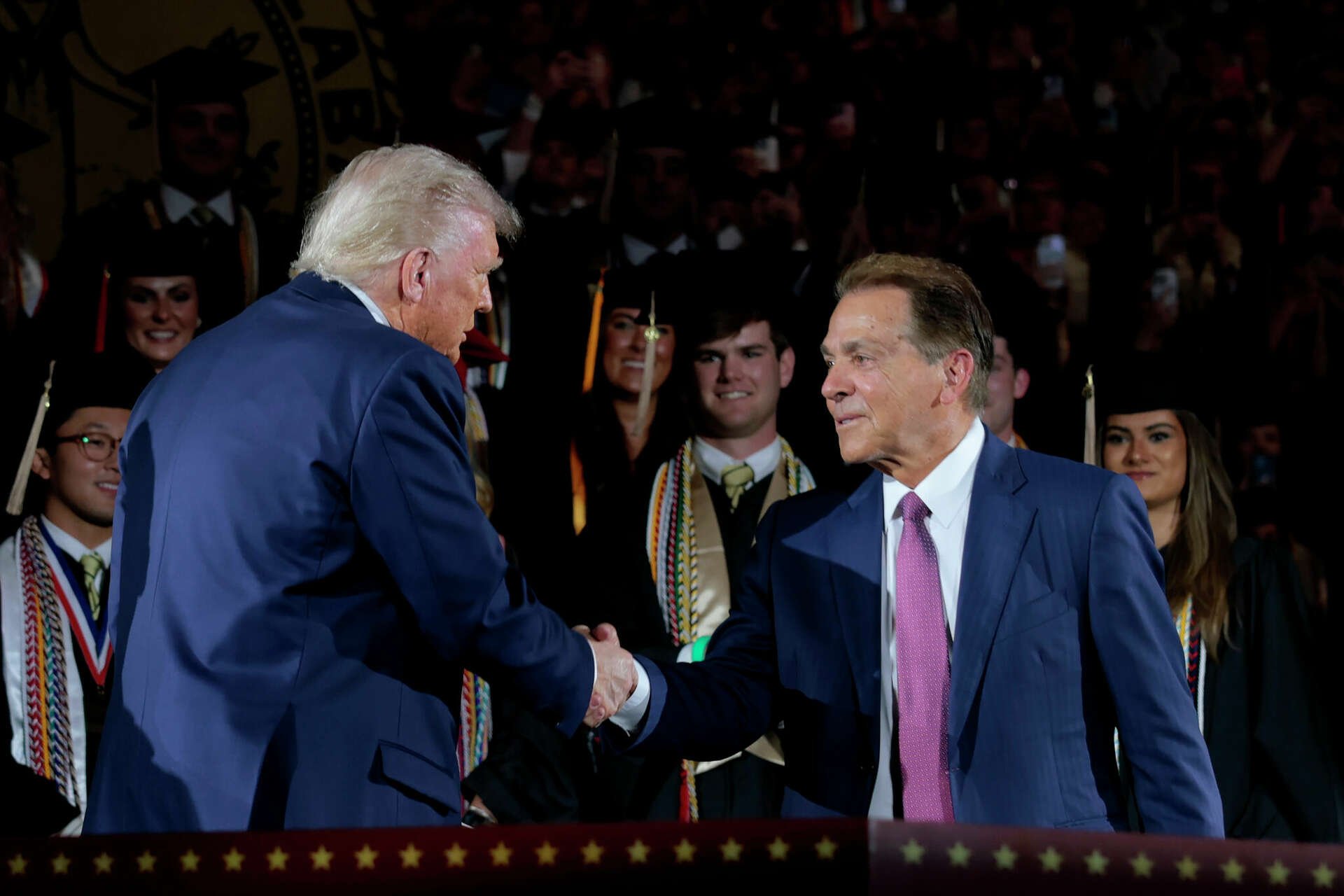 Nick Saban and Texas billionaire shaking hands